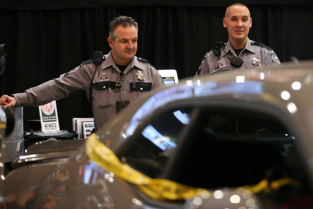 Nevada Highway Patrol spokesman Travis Smaka, left, and trooper Adam Whitmarsh, at the SEMA Sho ...