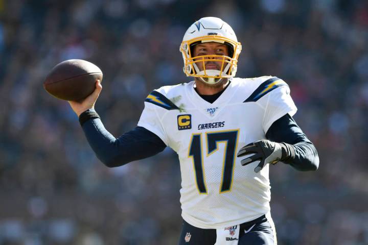 Los Angeles Chargers quarterback Philip Rivers, center, throws a pass during the second half of ...