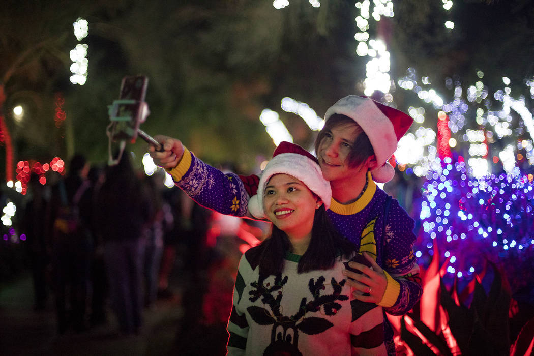 Dylan Rahilly takes a selfie with his wife, Heaven Magno, at the Ethel M Chocolates cactus gard ...