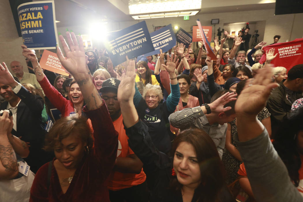 Democratic supporters cheer their candidates at a Democratic Party event in Richmond, Va., Tues ...