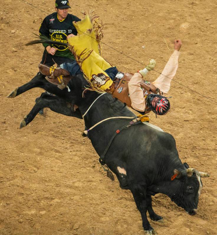 Daniel Tinsman flips over I'm Legit Too after getting the horns during the PBR Finals at T-Mobi ...