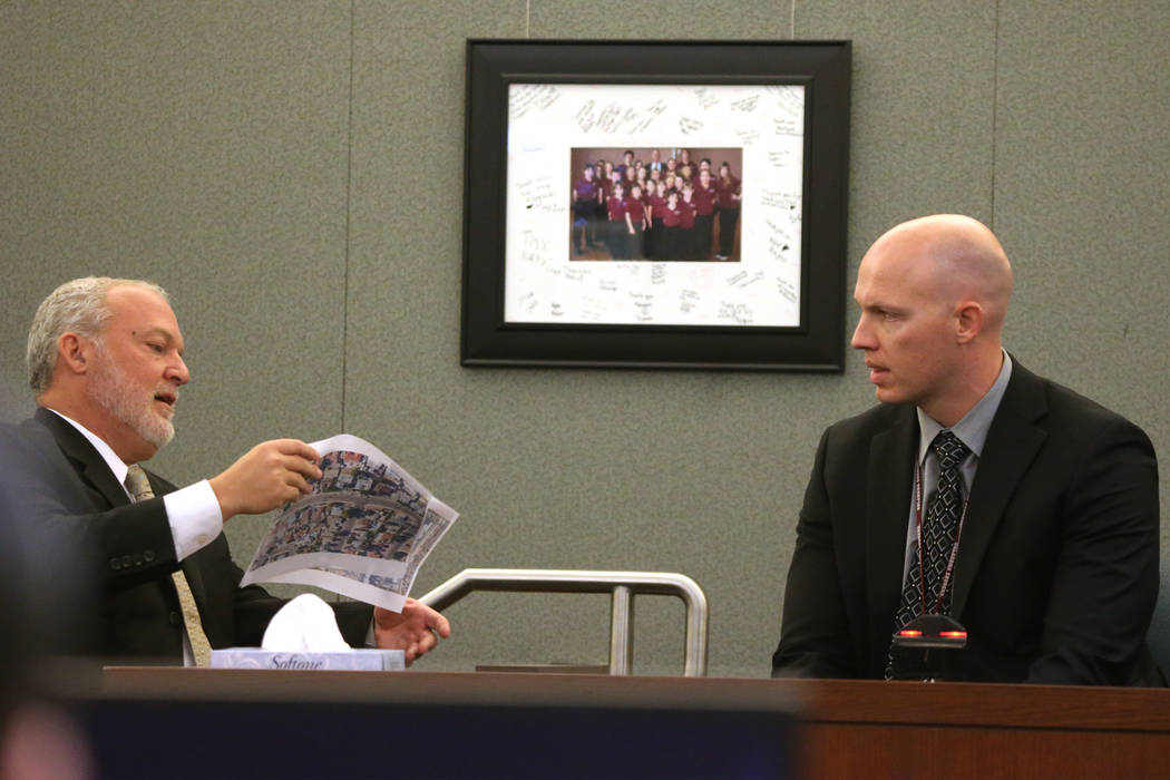 Chief Deputy District Attorney Marc DiGiacomo, left, speaks to witness Las Vegas police officer ...