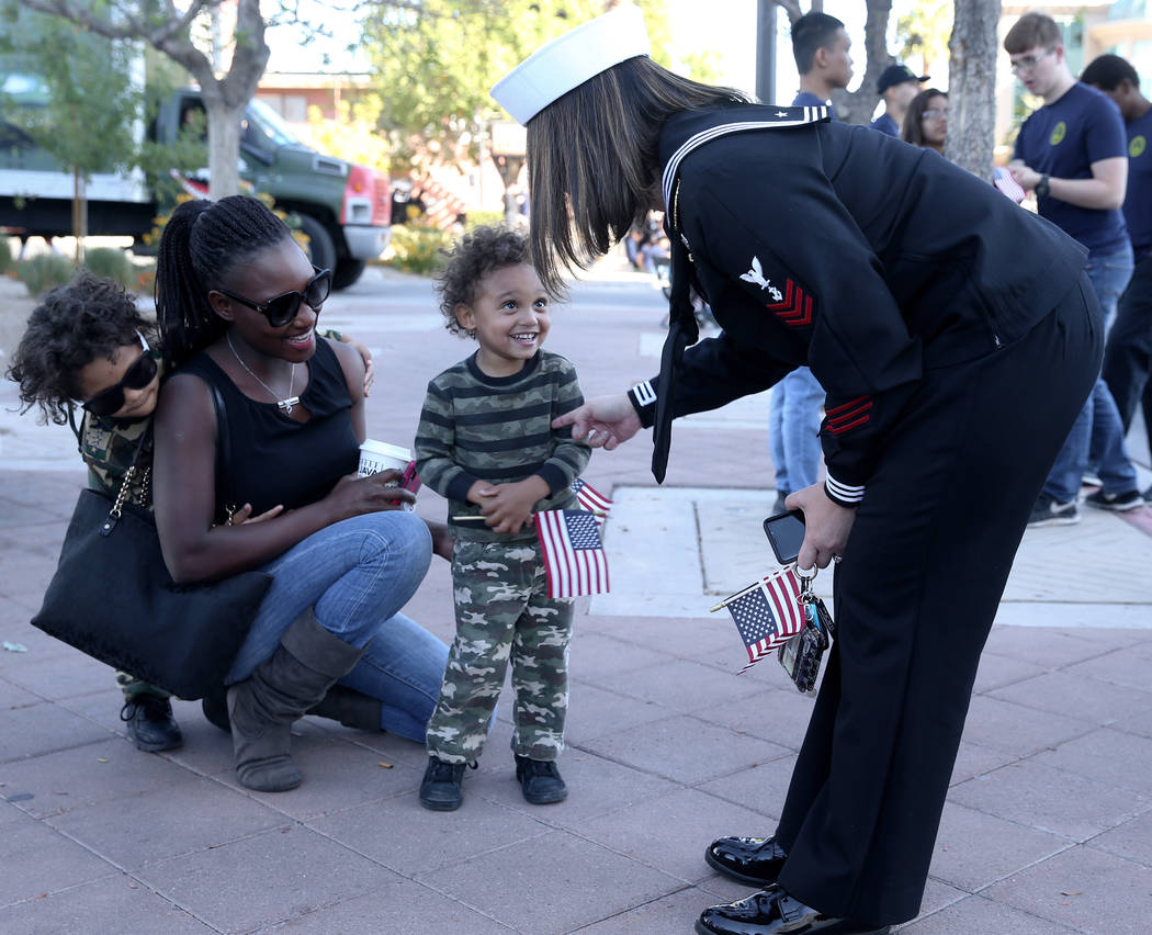Chris Nelson, 3, greets Navy petty officer first class Ruth Dobson, 36, as his mother Susan Nel ...