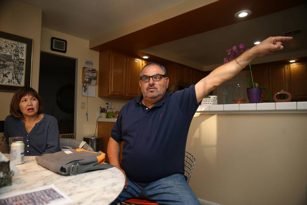 Victor Padron, right, with his neighbor Lori Niimi, talks about a rehab center that opened next ...