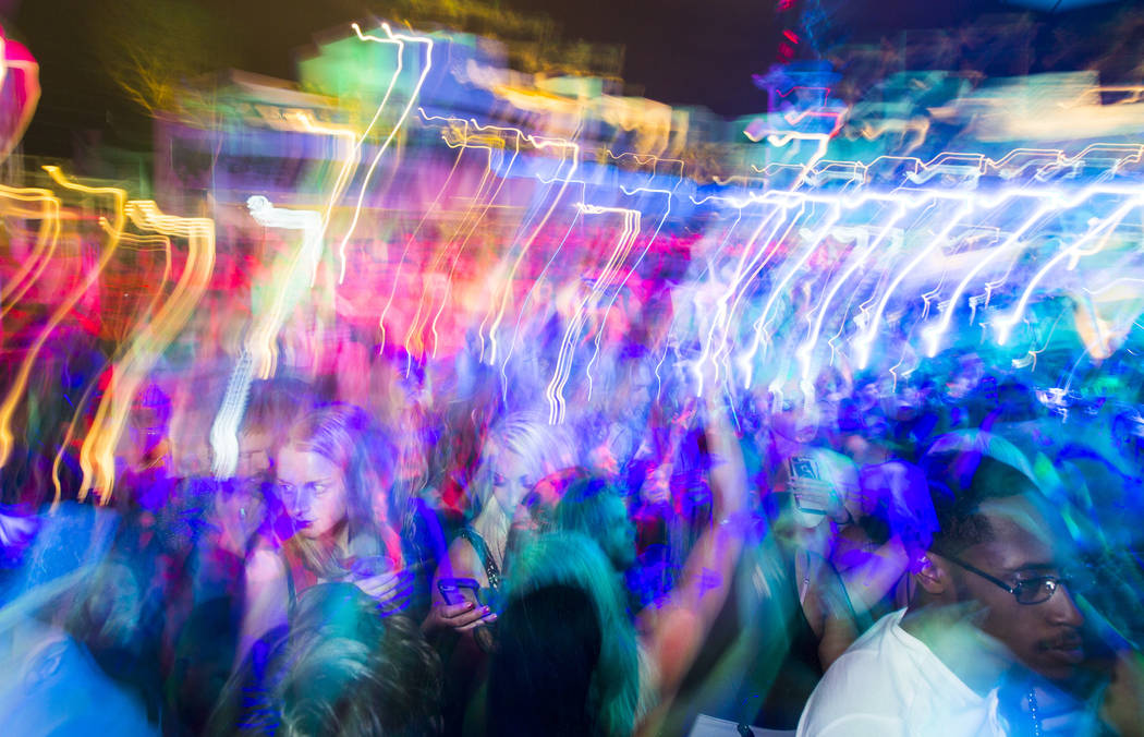 Attendees dance and listen to music as performers entertain by the outdoor stage during the gra ...