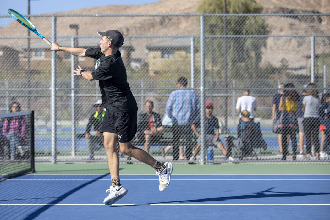 Palo Verde High School's Benjamin Waid jumps to serve during a doubles match with his partner W ...