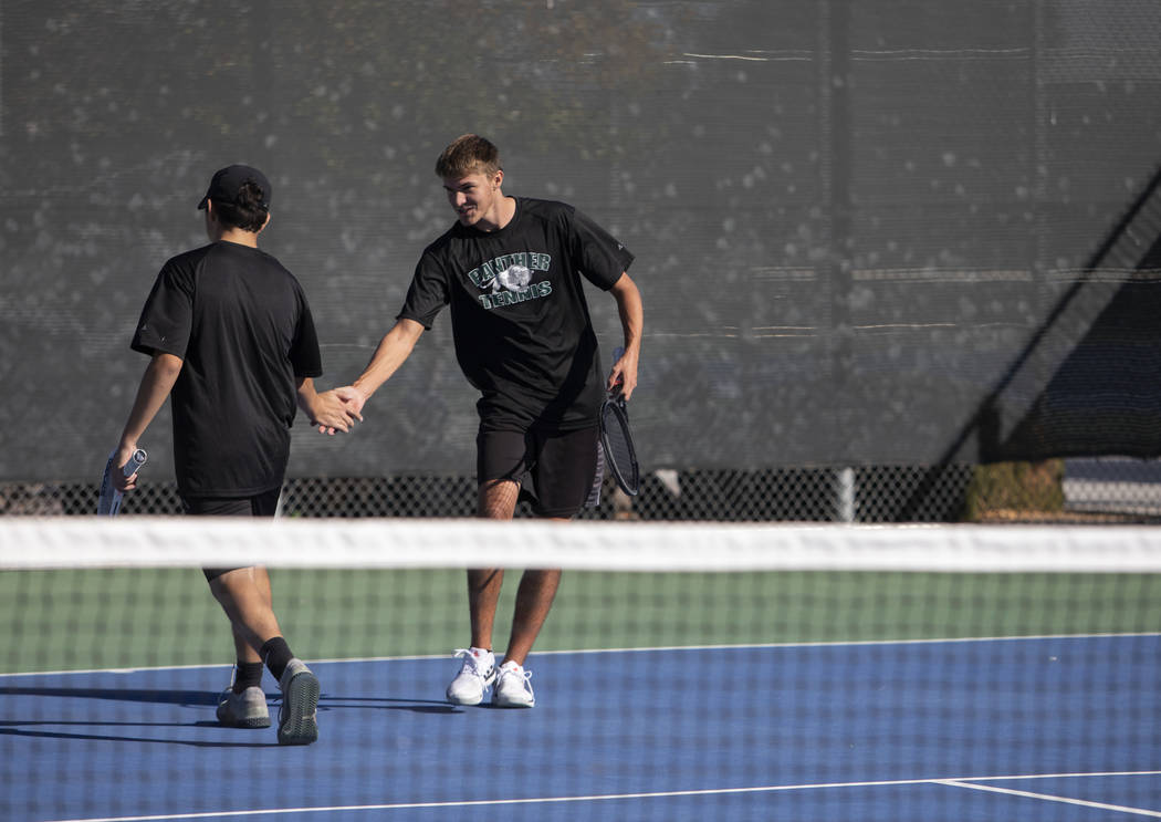 Palo Verde doubles partners Ryan Jensen, left, and Tyler Juhasz right, high five after earning ...