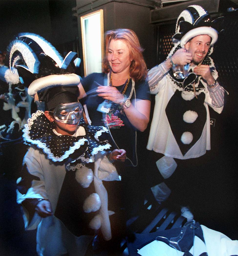 Carol Windish of the Rio helps guests Lauren Martinez and Marc Adler with their costumes as the ...