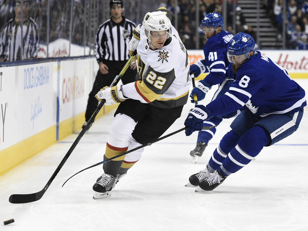 Vegas Golden Knights defenseman Nick Holden (22) moves around Toronto Maple Leafs defenseman Ja ...