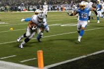 Oakland Raiders running back Alec Ingold (45) runs toward the end zone to score past Los Angele ...
