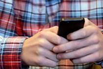 FILE - In this Oct. 24, 2013, file photo, a person checks their smartphone in Glenview, Ill. A ...