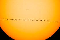 In a composite image provided by NASA, the planet Mercury passes directly between the sun and E ...