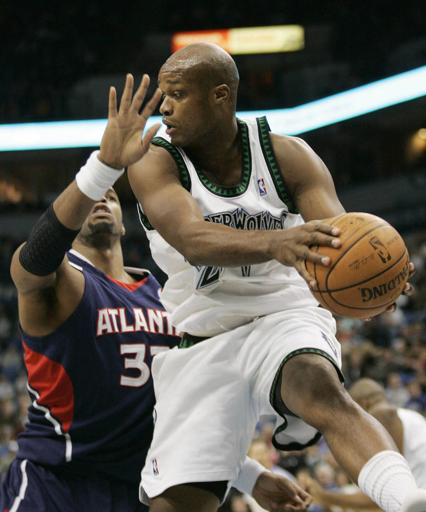 Minnesota Timberwolves forward Antonie Walker, right, pulls in a rebound in front of Atlanta Ha ...