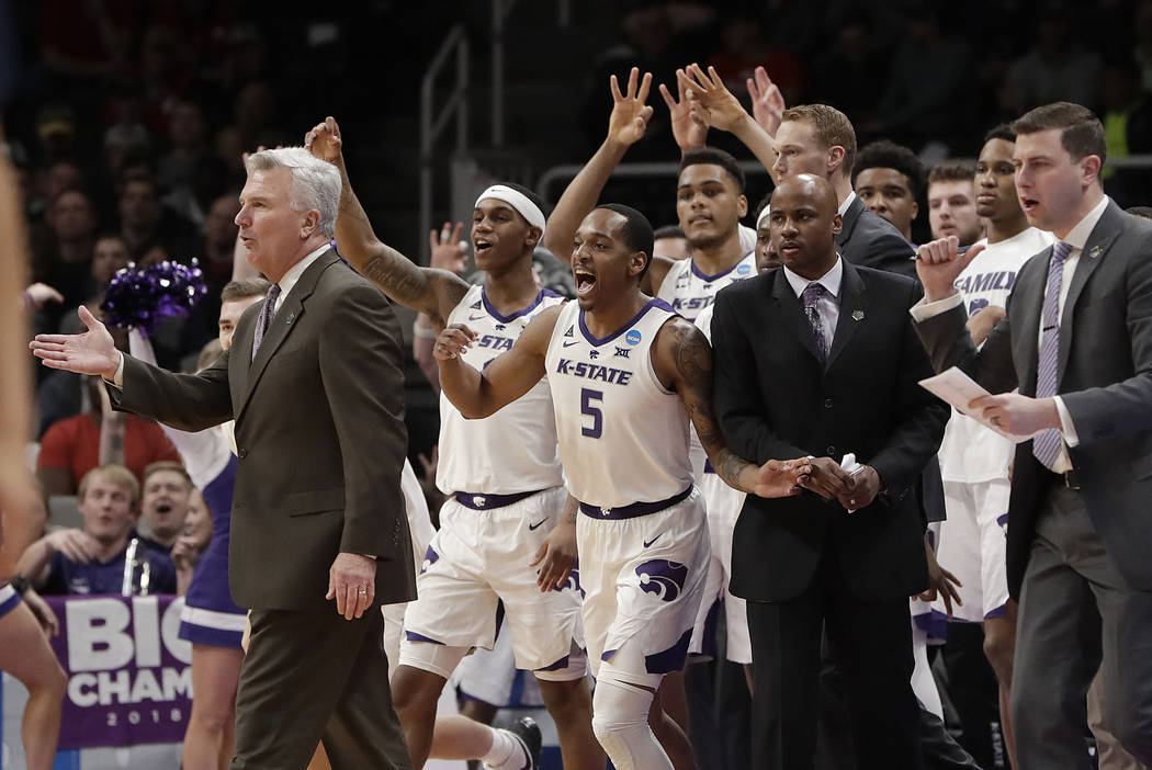 Kansas State head coach Bruce Weber, left, gestures as players celebrate during the first half ...