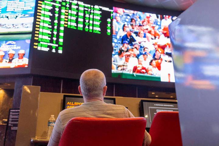 Betters watch live sports at the CG Technology sports book at the newly renovated Palms in Las ...