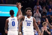 Memphis' James Wiseman (32) is congratulated by D.J. Jeffries (0) during the first half of an N ...