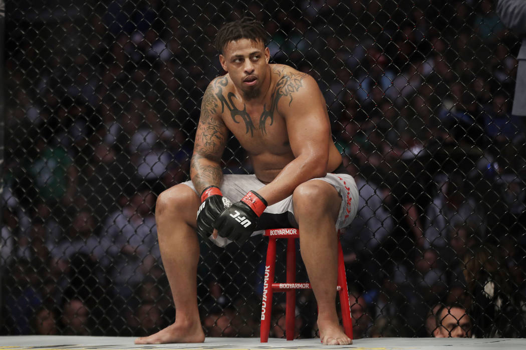 Greg Hardy sits during a break in a heavyweight mixed martial arts bout against Ben Sosoli, Fri ...