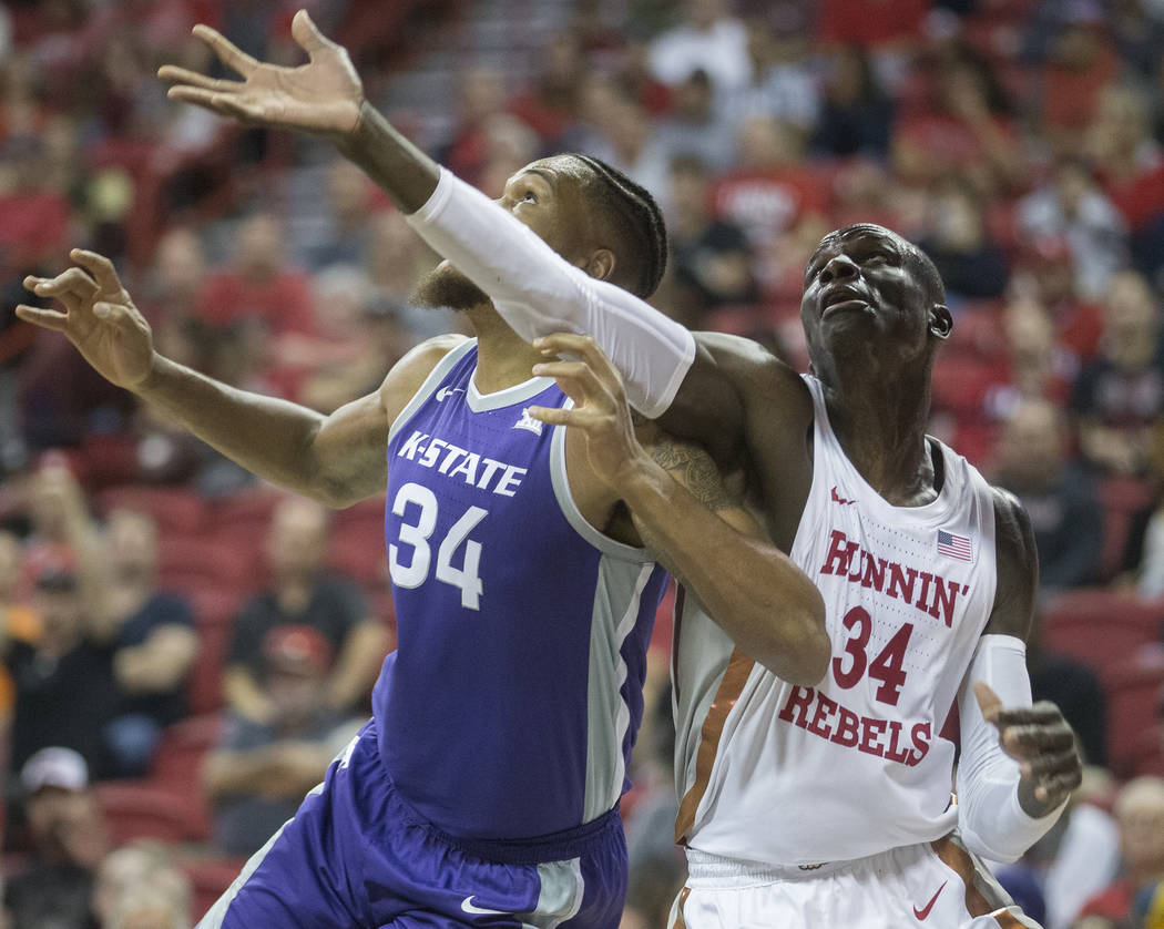 UNLV Rebels forward Cheikh Mbacke Diong (34) fights for a rebound with Kansas State Wildcats fo ...