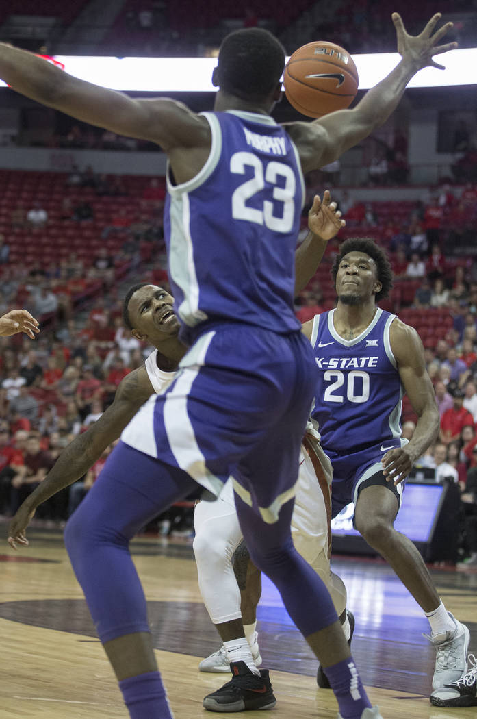 UNLV Rebels guard Amauri Hardy (3) fights for a loose ball with Kansas State Wildcats forward X ...