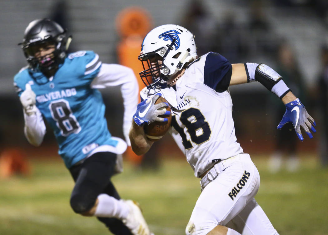 Foothill's Thomas Fisher-Welch (18) runs the ball against Silverado's Ryan Kelly (8) to score a ...