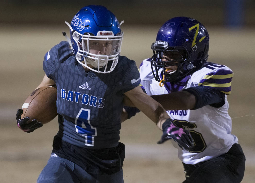 Green Valley's Brady Clayton (4) makes a reception past Durango's Michael Hayword (6) in the se ...
