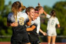Faith Lutheran's Amelia McManus (20, center) celebrates a goal with teammates Addy Radwanski (1 ...