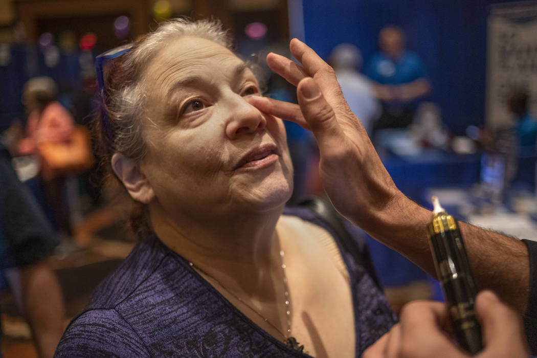 Jan Cobb of Las Vegas tries an anti-aging skincare product at the AgeWell Expo on Saturday, Nov ...