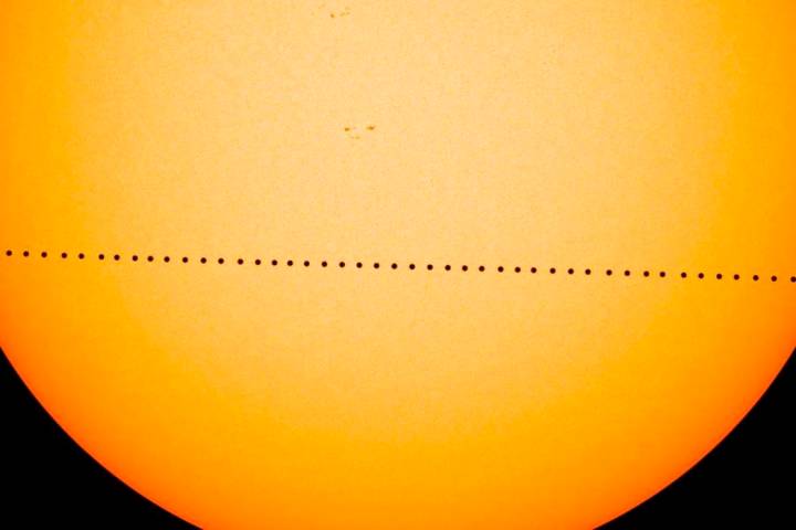 In a composite image provided by NASA, the planet Mercury passes directly between the sun and E ...