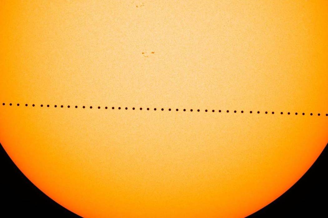 In a composite image provided by NASA, the planet Mercury passes directly between the sun and E ...