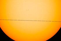 In a composite image provided by NASA, the planet Mercury passes directly between the sun and E ...