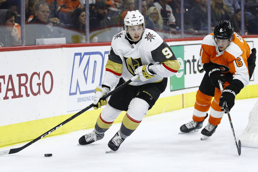 Vegas Golden Knights' Cody Glass (9) takes the puck past Philadelphia Flyers' Travis Sanheim du ...