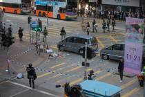 Police cordons off the scene of a morning shooting in Hong Kong Monday, Nov. 11, 2019. Police i ...
