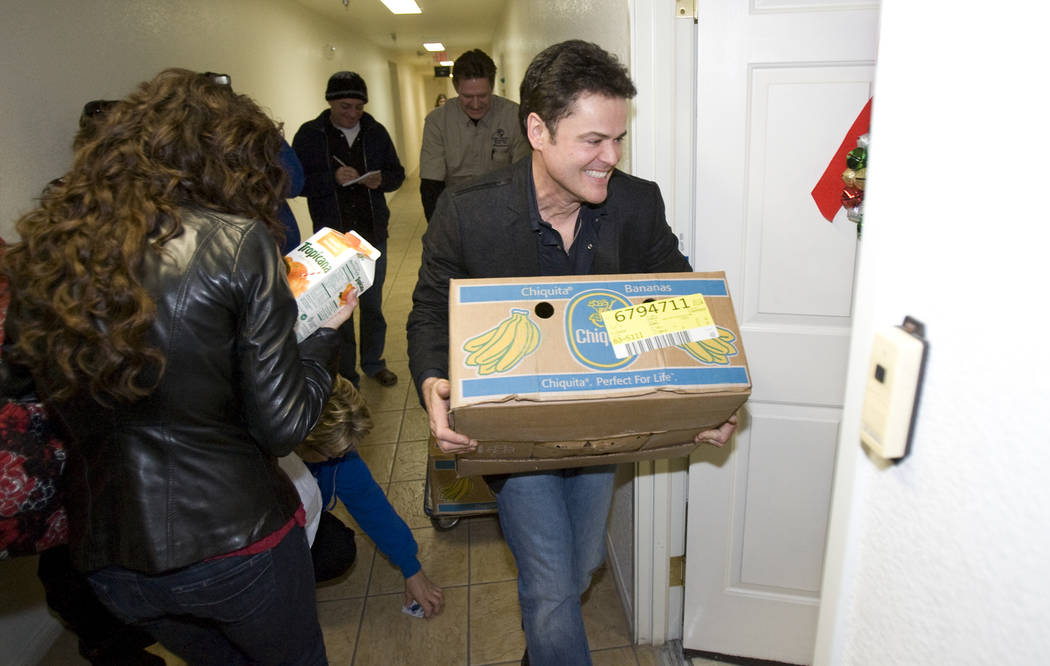 Donny and Marie Osmond deliver food at Louise Shell Senior Apartments, 2121 N. Martin Luther Ki ...