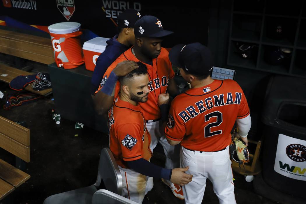 Houston Astros' Yordan Alvarez, Alex Bregman and Jose Altuve huddle after Game 7 of the basebal ...
