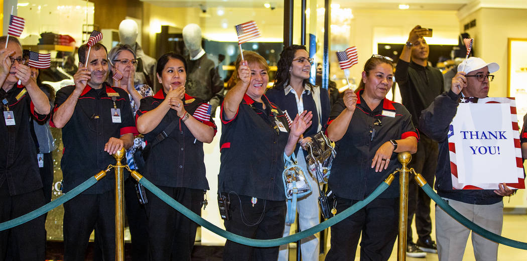 Employees from The Venetian gather to applaud as wounded veteran's and family members enter the ...