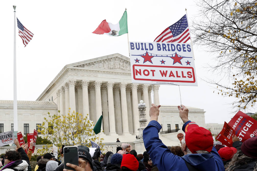 People rally outside the Supreme Court as oral arguments are heard in the case of President Tru ...