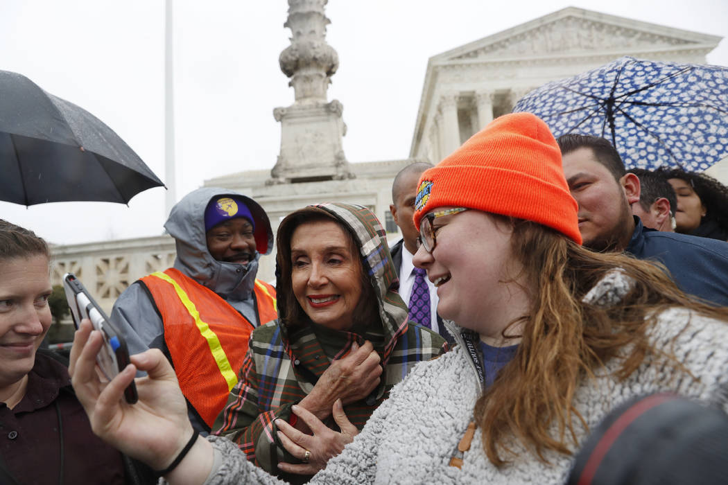 House Speaker Nancy Pelosi and other participants, outside the Supreme Court as oral arguments ...