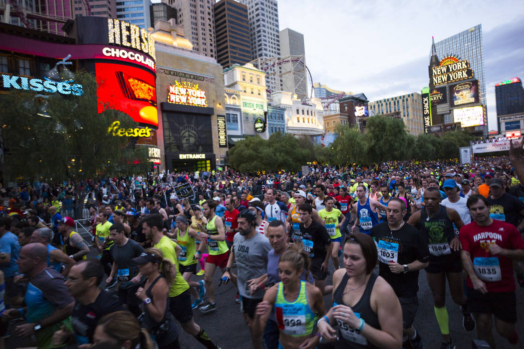 Participants head out from the start line outside of the New York-New York at the beginning of ...