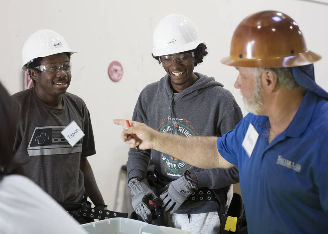 Tayvon Jenkins, left, and Dwayne Smith, right, speaks to their instructor Randy Griebel, far ri ...