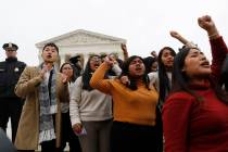 DACA recipients and others leave the Supreme Court with their hands in the air after oral argum ...