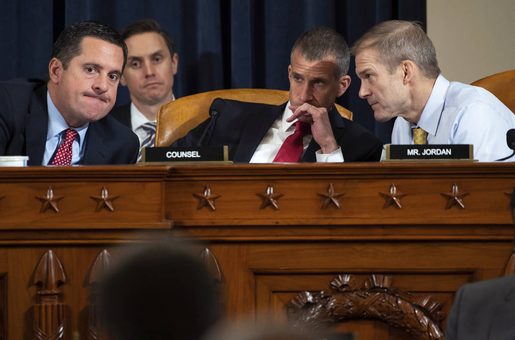 Ranking member Rep. Devin Nunes, R-Calif., left, confers with Rep. Jim Jordan, R-Ohio, right, a ...