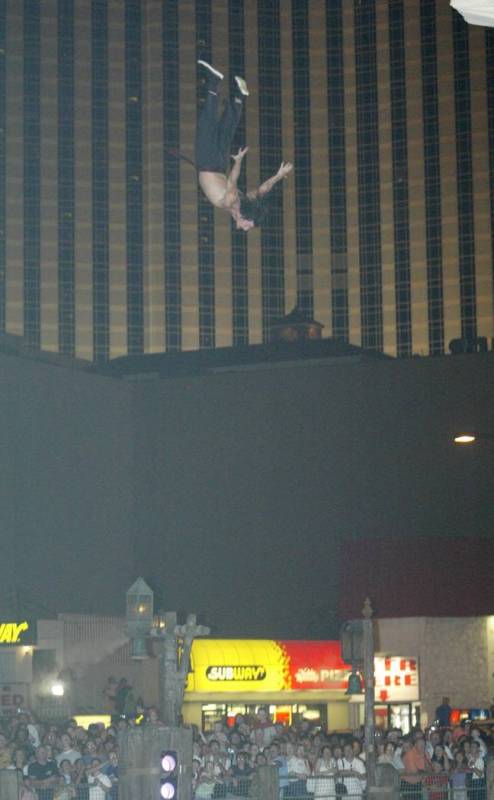 A "Battle of Buccaneer Bay" cast member takes a high dive from the mast of his ship during the ...