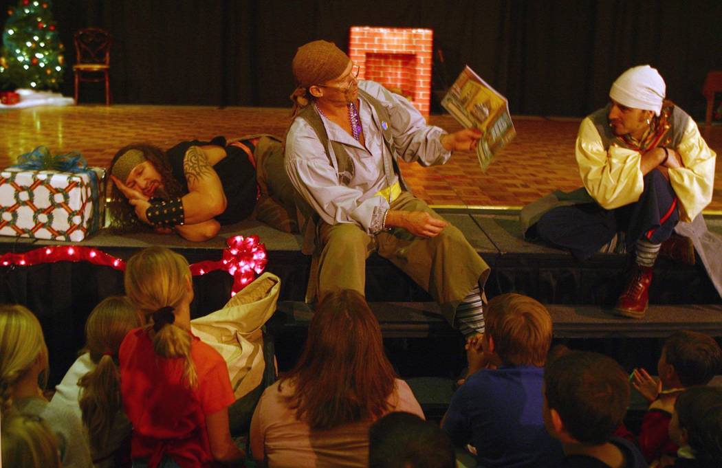 Pirates from "Battle of Buccaneer Bay" read a Christmas story at a Nov. 29, 2002 holiday festiv ...