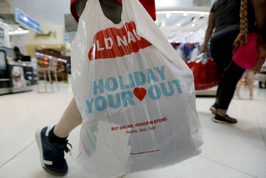 A Black Friday shopper walks through Dolphin Mall on Friday, Nov. 23, 2018, in Miami. (AP Photo ...