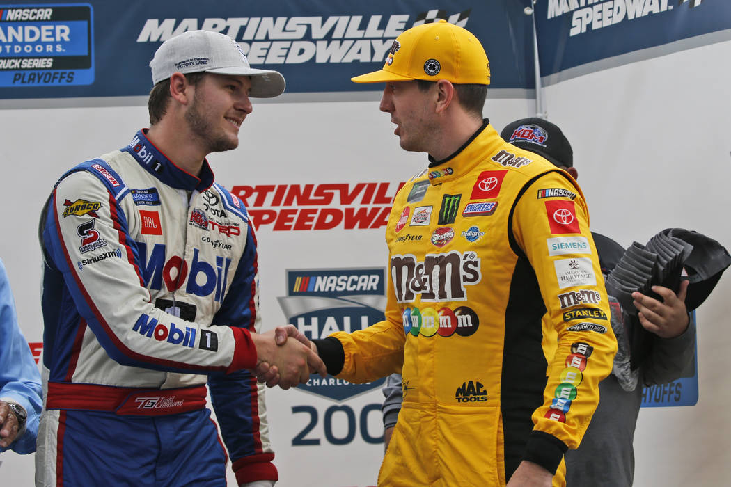 Kyle Busch, right, shakes the hand of Todd Gilliland as he celebrates winning the NASCAR Truck ...