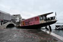 A stranded ferry boat lies on its side, in Venice, Wednesday, Nov. 13, 2019. The mayor of Venic ...