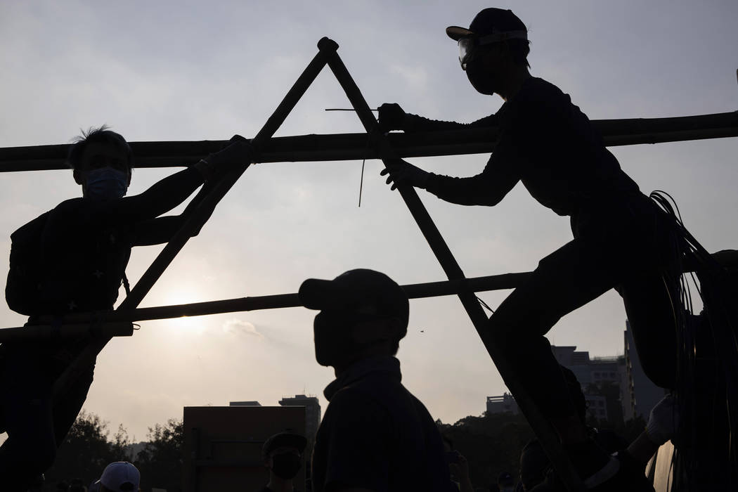 Protesters build additional barrier on a bridge which leads into the Chinese University of Hong ...