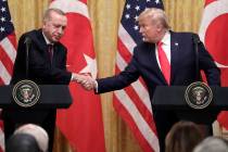President Donald Trump shakes hands with Turkish President Recep Tayyip Erdogan during a news c ...