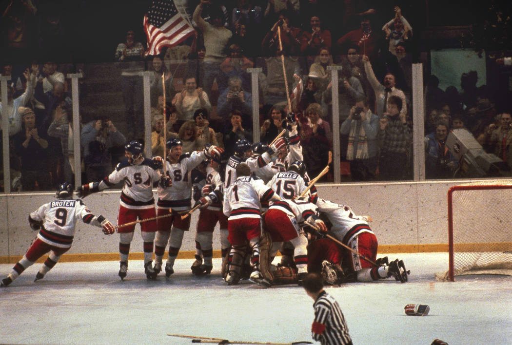 FILE - In this Feb. 22, 1980, file photo, the U.S. hockey team pounces on goalie Jim Craig afte ...