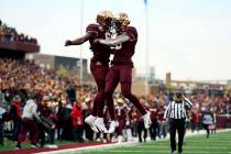 Minnesota wide receiver Rashod Bateman, right, jumps up in celebration with teammate Tyler John ...